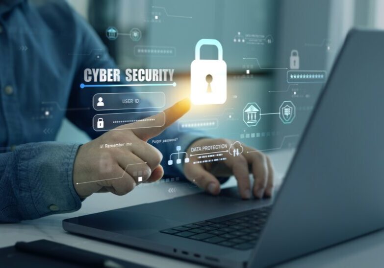Person interacting with cybersecurity interface on laptop.
